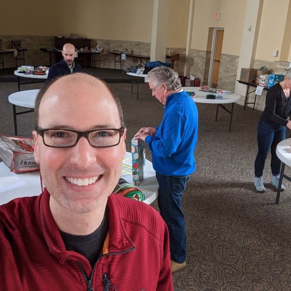 Evan Grove, Senior Director, mugging in front of our gift wrapping team
