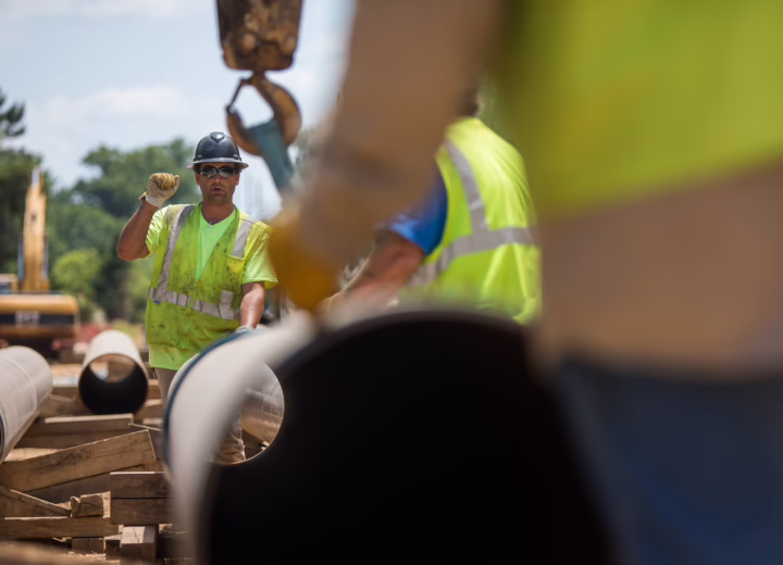 Construction workers building pipeline