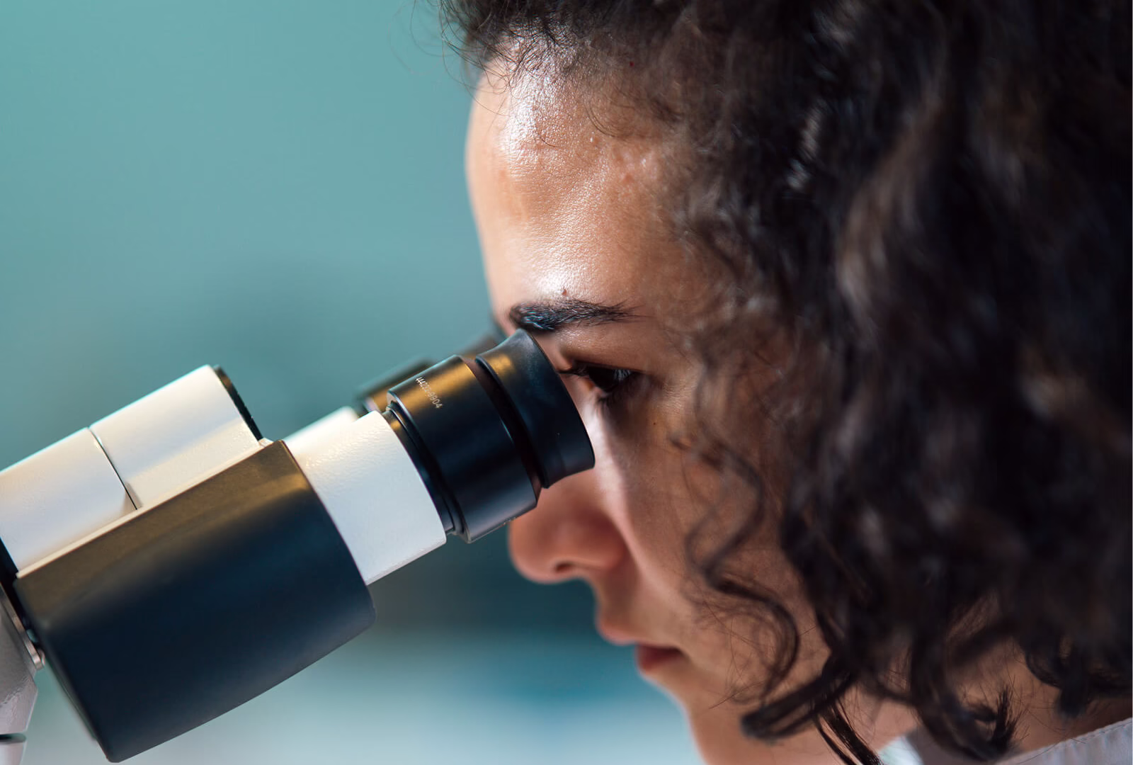 Woman looking through microscope