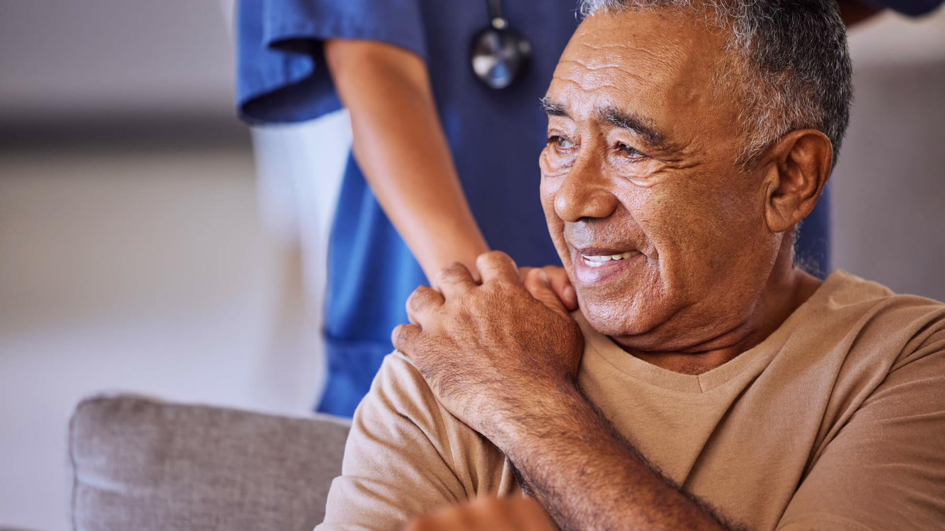 Patient holding hospital worker's hand