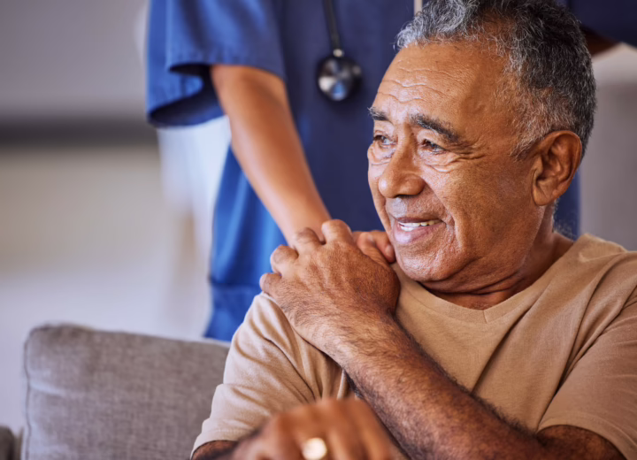 Patient holding hospital worker's hand