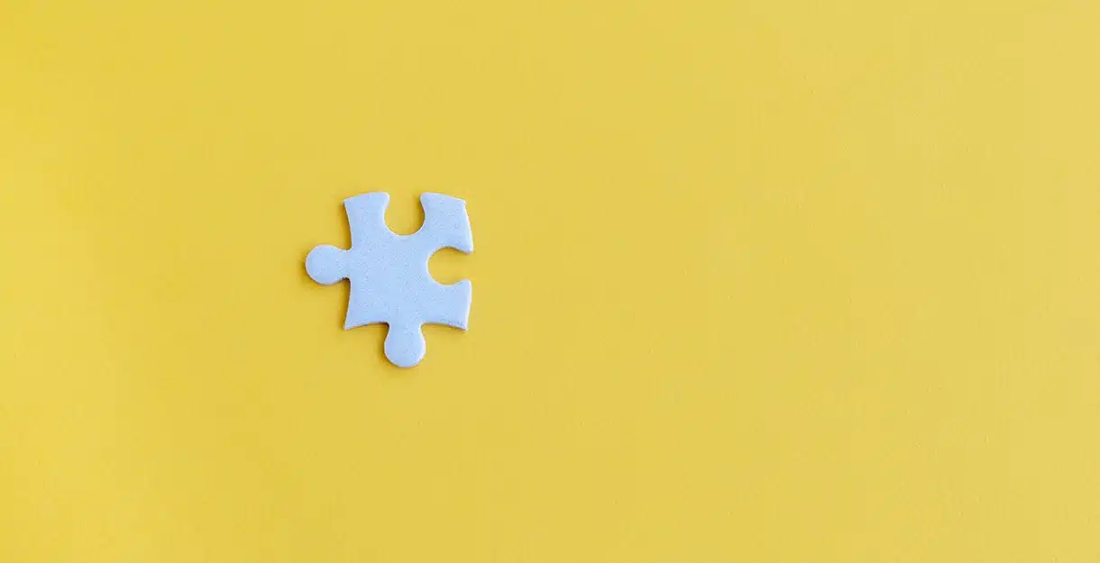 A jigsaw puzzle piece on a yellow Background.